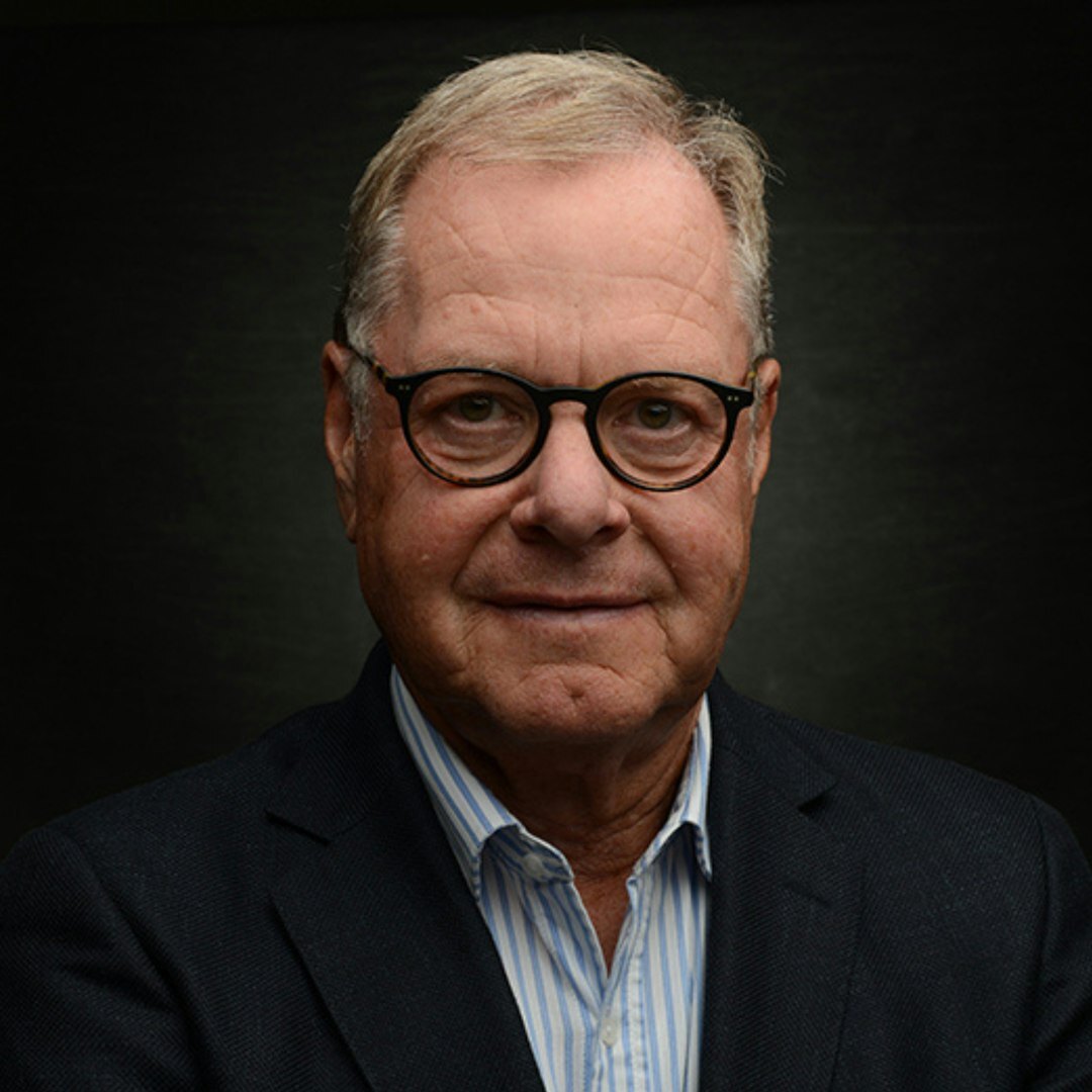 Studio portrait of a middle aged white businessman with glasses