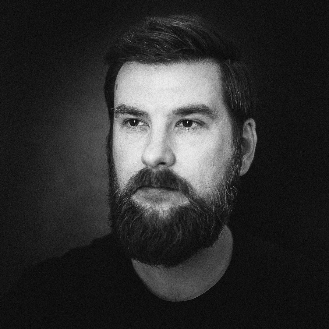 Studio portrait of a young white businessman with a beard